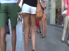 Cuties with amazing asses are captured on a streetside concealed webcam.